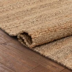 Romy Laylani Farmhouse Solid Pattern Natural 5 ft. x 7 ft. 6 in. Hand-Braided Chunky-Textured Jute Area Rug by Well Woven -Linon Home Decor Sales natural well woven area rugs rom 32 5 76 1000