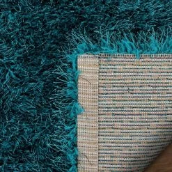 Kuki Chie Glam Solid Textured Ultra-Soft Teal 7 ft. 10 in. x 9 ft. 10 in. 2-Tone Shag Area Rug by Well Woven 17 Kuki Chie Glam Solid Textured Ultra-Soft Teal 7 ft. 10 in. x 9 ft. 10 in. 2-Tone Shag Area Rug by Well Woven -Linon Home Decor Sales teal well woven area rugs ku 18 7 44 1000