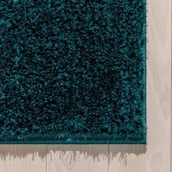 Rainbow Chroma Glam Solid Teal 5 ft. 3 in. x 7 ft. 3 in. Multi-Textured Shimmer Pile Shag Area Rug by Well Woven -Linon Home Decor Sales teal well woven area rugs ra 16 5 1f 1000